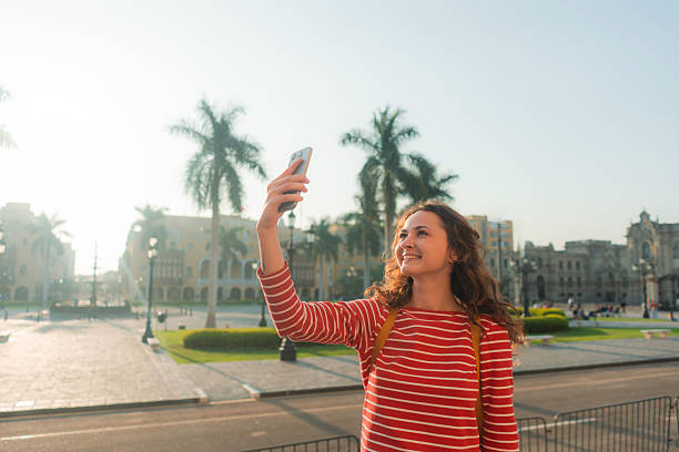 istock Woman using smartphone walking in Lima, Peru 2238955492