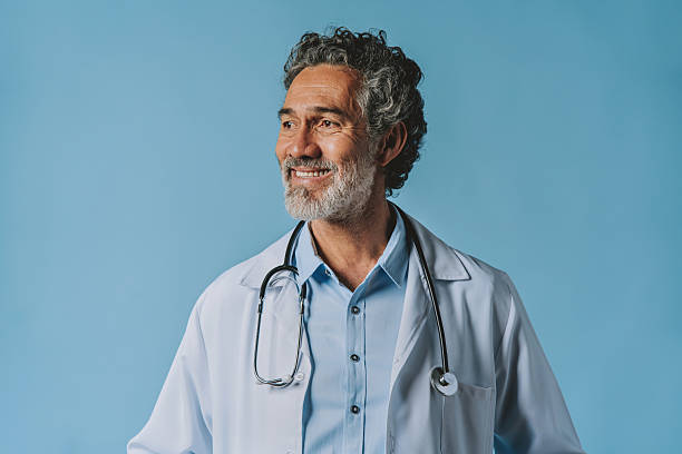 istock Smiling male doctor looking away 2238958451