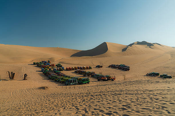Parking of sand buggies  on  the dune in Huacachina, Peru