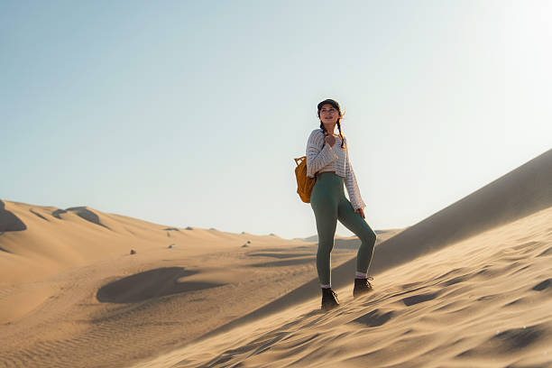 Adventurous woman exploring  Huacachina desert oasis in Peru