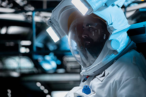 Asian chinese mid adult female astronaut typing in front of computer