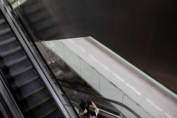Empty escalator in a contemporary underground metro station with metallic design.