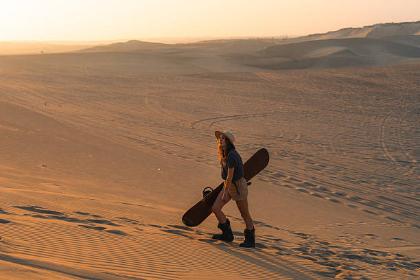 istock Woman sandboarding in desert in Peru 2238960926