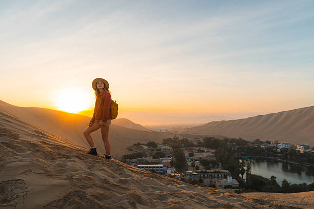 istock Woman exploring desert oasis in Peru at sunrise 2238961156