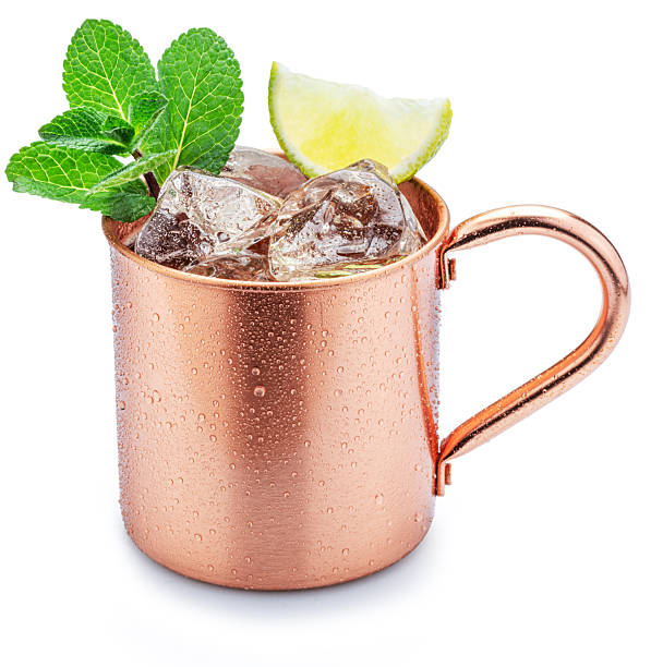 istock Copper cup with Moscow mule drink decorated with lime and mint leaves white background. Clipping path. 2238961453