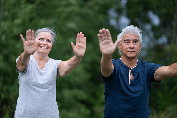 istock Happy Senior Couple Exercising Outdoors With Hands Raised In Unity And Wellness 2238965139