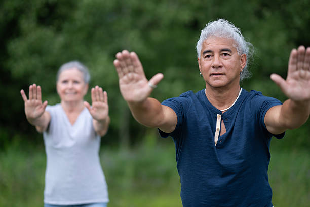 istock Older Boomer Couple Outdoors Practicing Balance And Wellness Through Stretching 2238965155