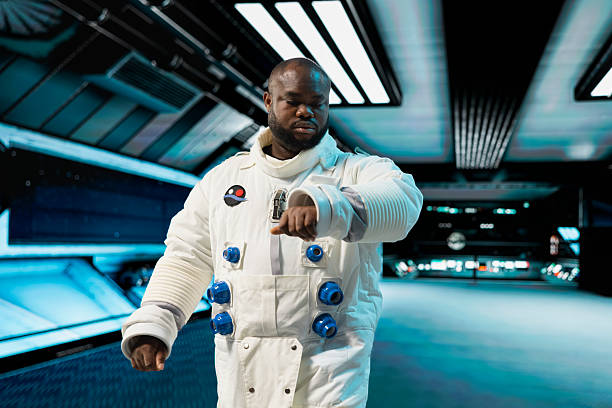 Astronaut in spaceship looking at wrist device to confirm suit integrity, preparing for planetary mission outside. Orbital station crew member testing gear during routine equipment check