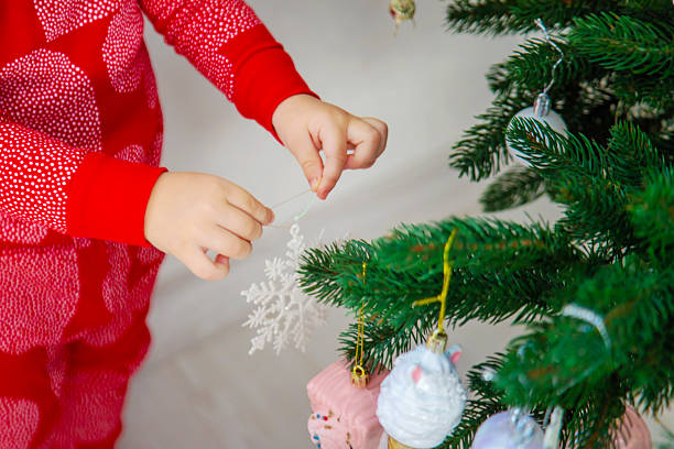 Little Girl Decorating the Christmas Tree.