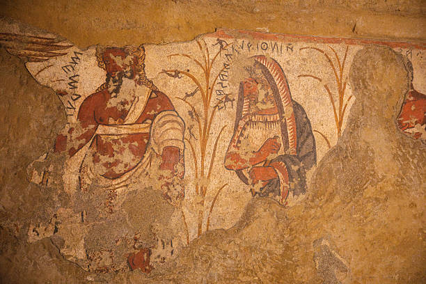 Ancient wall painting inside an Etruscan tomb in Tarquinia, Italy. This archaeological fresco, dating back to the Etruscan civilization of the 7th–3rd century BC, is part of the UNESCO World Heritage necropolis, offering a unique testimony of early Italic funerary art.