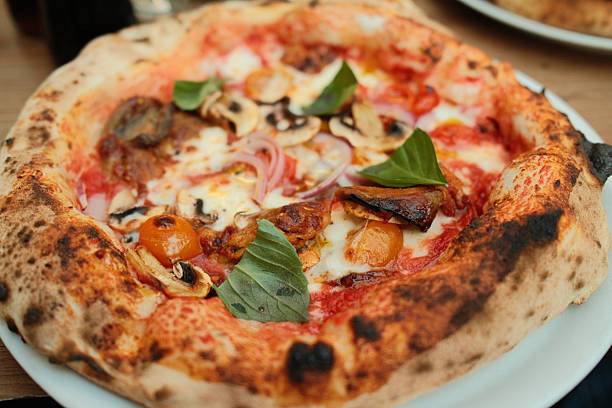 Neapolitan pizza with mushrooms basil and cherry tomatoes