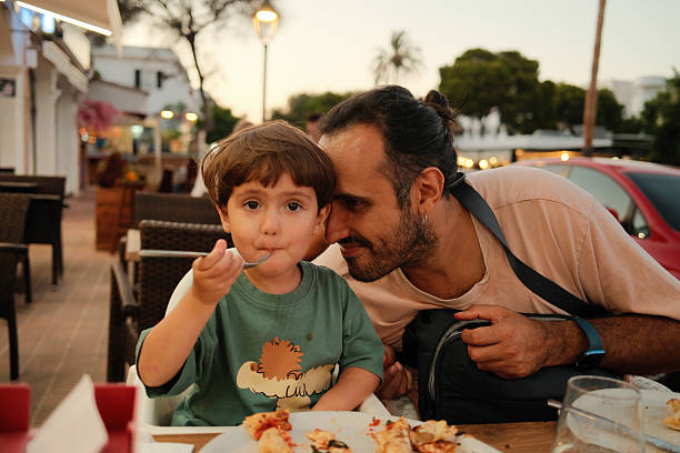 istock Father and son enjoying dinner at a casual restaurant 2238979665
