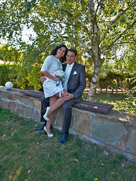 A mature couple, husband and wife, are celebrating their wedding anniversary with their children. A country recreation center on the shore of a lake, in September.