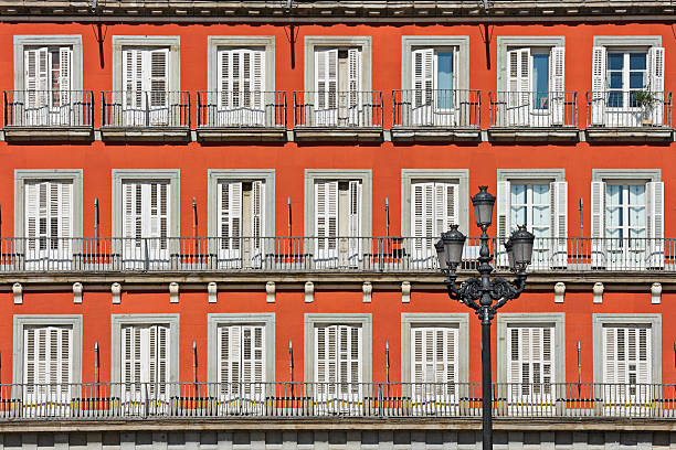 Symmetrical facade with shuttered windows and balconies Madrid, Spain.