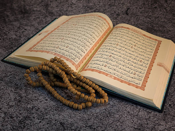 istock Opened page Holy Quran tasbih or rosary beads on top. 2238981882
