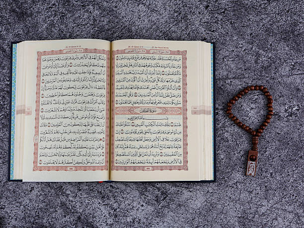 istock Opened page Holy Quran tasbih or rosary beads on top. 2238981889