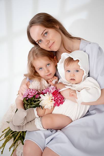mother with children, with little daughters on a white isolated background, space for text, mother and child.