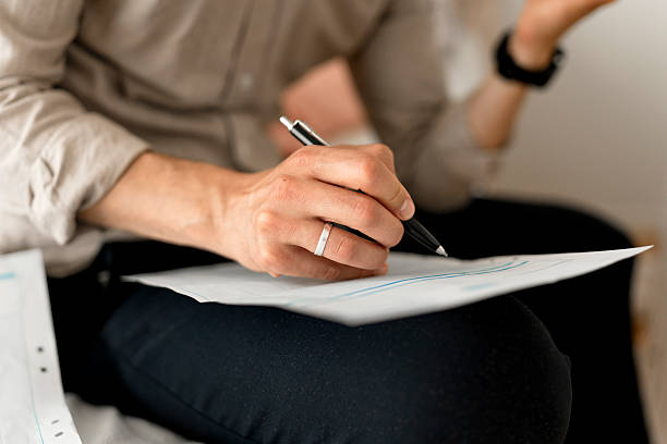 istock Man reviews financial statements at home, using AI assistant on smartphone to help with calculations 2238986168