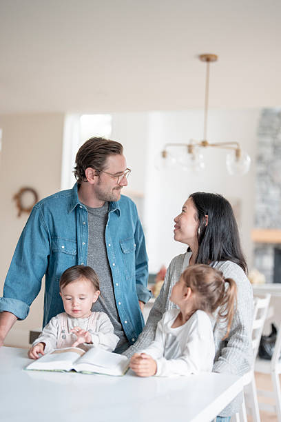 istock Happy Multicultural Family At Home Reading Together At Bright Kitchen Table 2238987755