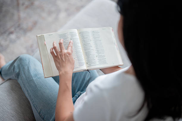 istock Woman Reading Open Book While Sitting On Couch At Home, Casual Study Moment 2238987812