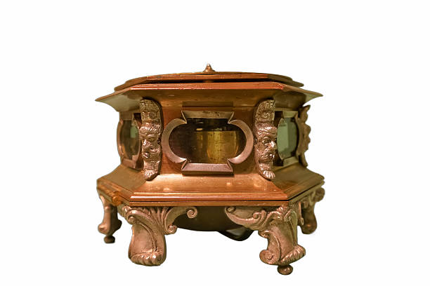 This decorative incense holder features a unique octagonal shape with detailed carvings and ornate legs. It showcases craftsmanship with glass panels, ideal for use in relaxation spaces or rituals.