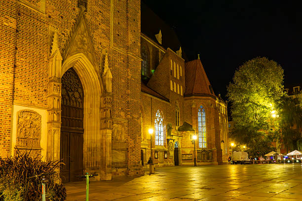 the famous Frauenkirche in Nuremberg at night with red and white roofs of christkindlesmarket stalls, Germany, Franconia, Bavaria.