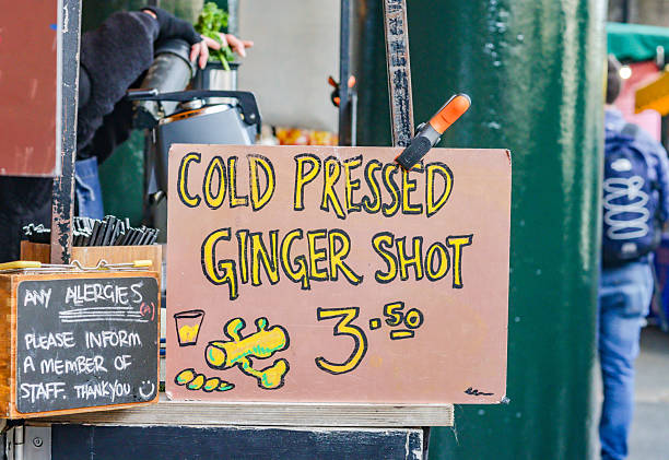 Cold Pressed Ginger Shot in Borough Market, London, with a design element visible.