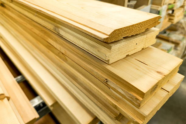 istock Stacked wooden boards ready for construction projects in a lumber yard during daylight hours 2239000551
