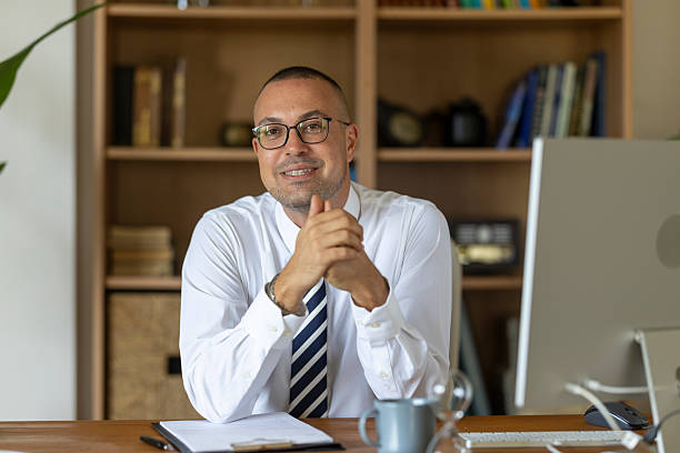 istock Confident businessman smiling, working in home office with hands clasped 2239001580