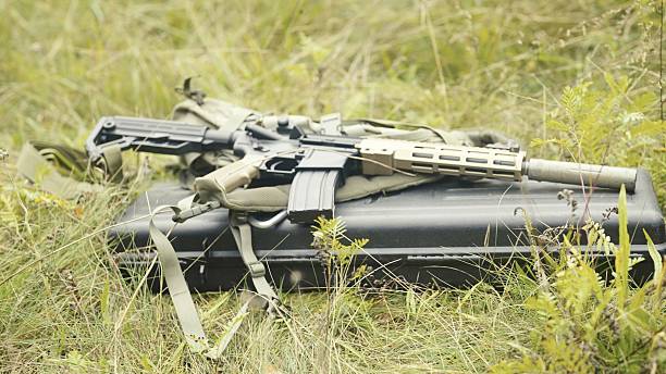 Military equipment on the ground. AR-15 carbine
