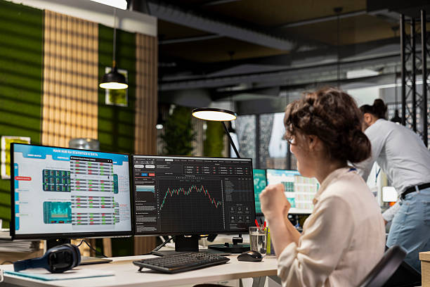 istock Pleased finance advisor celebrating global market trends progress 2239002530