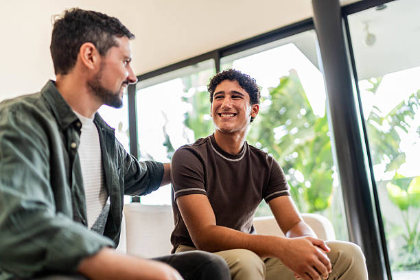 istock Father and son talking at home 2239004353