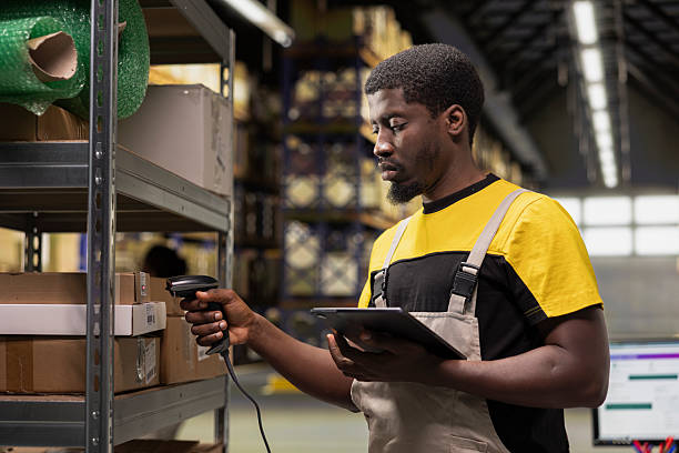 istock Warehouse male worker scanning tracking info numbers on barcodes tags 2239008487