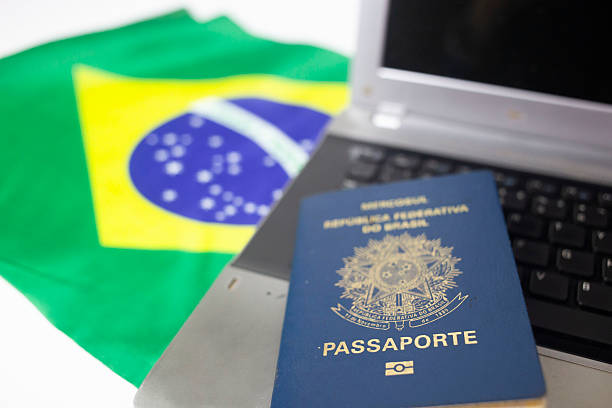 istock Brazilian flag and passport with laptop 2239009252