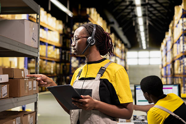 istock Call center female worker answers help line call in a logistics warehouse 2239009743