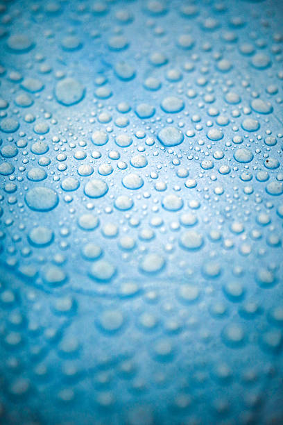 istock Water Droplets on Blue Surface, Rain Consept , Writing Area with Raindrops 2239010794