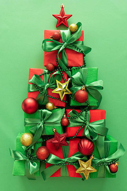istock Christmas Tree Made of Gift Boxes with Ornaments on Green Background 2239016902