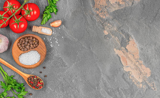 istock Fresh tomatoes, parsley, garlic, peppercorns and coarse salt on stone background with copy space. Cooking ingredients for recipe, mockup template for text or menu design 2239023627