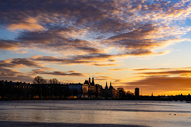 View of the city skyline at sunset with colorful clouds over the waterfront in Copenhagen, Denmark, January 2025.