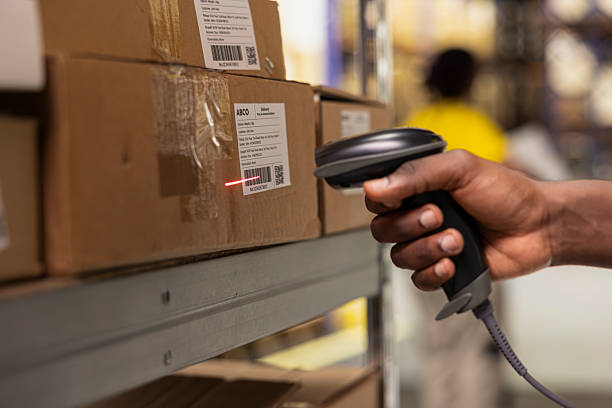 istock Close up of black worker scanning the barcode awb tags on cargo boxes 2239028231