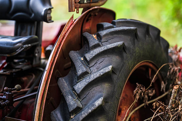 Close-up of a dirty tractor tire with visible cracks and texture
