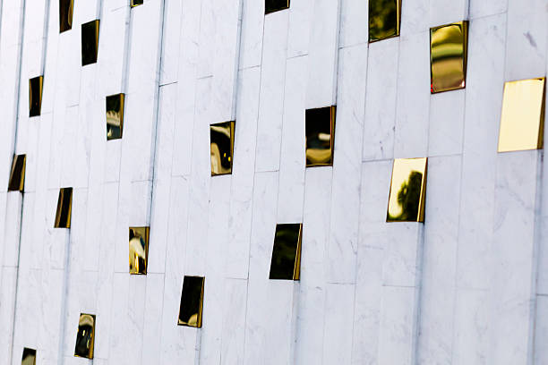 Gold colored geometric shapes at marble wall