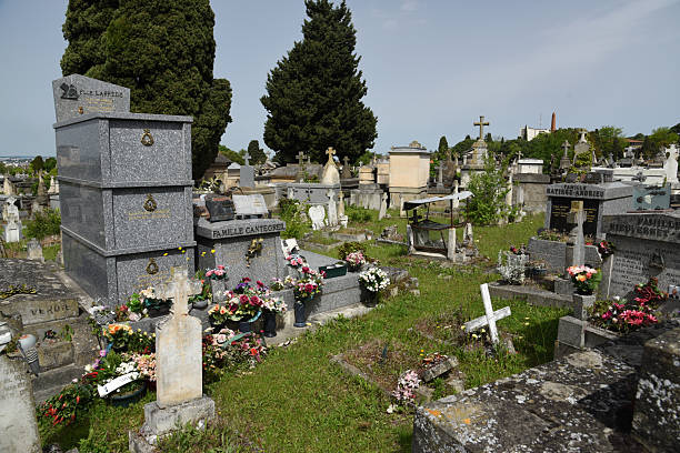 Terre-Cabade Cemetery in Toulouse stands as the largest cemetery in the region, sprawling across a 33-hectare area on the Jolimont hillside. The oldest part of the Cemetery was realized in 1840. The image shows several graves, captured during spring season.