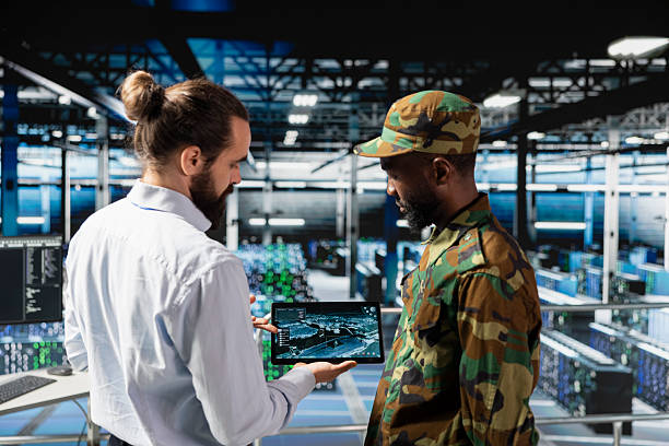 istock Military server room IT professionals using AI LLM tech on laptop 2239034829
