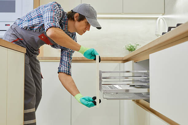 istock A Professional Installer is Engaged in Installing a Modern Kitchen Appliance. Skilled technician carefully installs a modern pull-out furniture boxes 2239034968