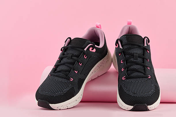 istock Black and pink athletic shoe with speckled sole, displayed against a pink backdrop, showcasing modern design and comfortable style 2239035365