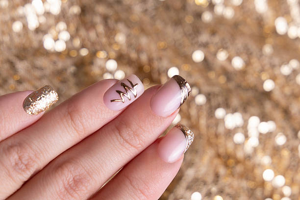 istock Female hand with golden manicure nails 2239035585
