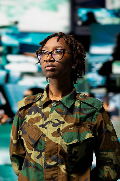 istock Female soldier wearing uniform in command center does surveillance 2239037751