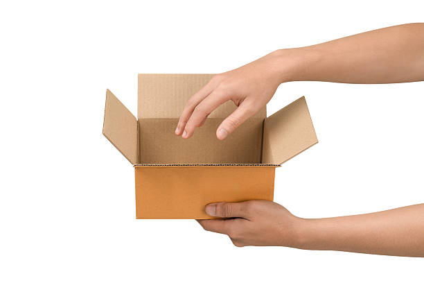 istock Hand holding an open empty cardboard box, isolated on a white background. This concept is suitable for transportation, business, delivery, e-commerce, logistics, and online shopping. 2239042312