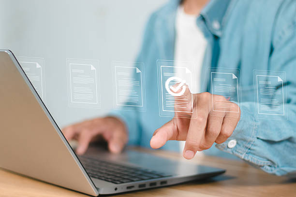 istock Businessman hand touching to online electronic paper for approve ISO quality document control certification and project approval concept. 2239042451